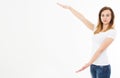 Caucasian girl in tshirt isolated on white background showing copy space by hands. European young woman. Mock up