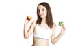 Caucasian girl.Weight loss, slim body, diet, sport, fitness and health concept. young beautiful woman holding broccoli and apple Royalty Free Stock Photo