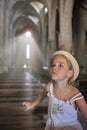 A girl in white dress is sitting and praying in the ancient church Royalty Free Stock Photo