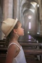 A girl in white dress is sitting and praying in the ancient church Royalty Free Stock Photo