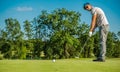 Caucasian Golf Player Using Putter Club Royalty Free Stock Photo