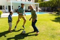 Caucasian grandfather, father and son playing football together in the garden Royalty Free Stock Photo