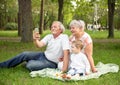 Caucasian grandparent with grandson having video chatting with family