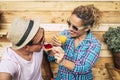 Caucasian guy and adult woman at home in the terrace having breakfast together with a funny face of the teenager whil he`s eating