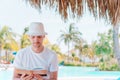 Caucasian guy relaxing near pool with amazing view and reading book Royalty Free Stock Photo