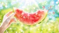 Caucasian hand holding a slice of watermelon against a sunlit background. Concept of summer, freshness, fruit, natural