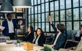 Caucasian handsome businessman wearing formal suit, raising hand to ask question or vote in meeting room at office while Royalty Free Stock Photo