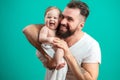 Playful father carrying his smiling infant child on neck over blue background Royalty Free Stock Photo