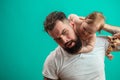 Playful father carrying his smiling infant child on neck over blue background Royalty Free Stock Photo