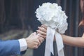 Caucasian handsome man giving flowers to asian girlfriend asking for proposing to marry him at green park. Couple lover on Royalty Free Stock Photo