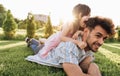 Caucasian happy dad is spending time with his little daughter outdoors. Happy cute little girl playing with her father in the park Royalty Free Stock Photo