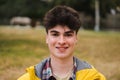 Caucasian happy guy standing in university campus. Portrait of teenage male student looking at camera in a college Royalty Free Stock Photo