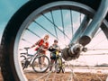 Caucasian Happy Mother And Son Riding Together And Posing For Photo. View From Bicycle Wheel, Family Riding Bicycles