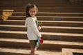 Caucasian happy smiling elementary age school child skater with skateboard outdoor. Active little girl with penny board