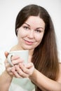 Caucasian happy smiling woman holding tea mug in hands, grey background Royalty Free Stock Photo