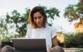 Caucasian hipster girl using tablet outdoors, cheerful young freelancer working on touch pad at green park, female student study Royalty Free Stock Photo