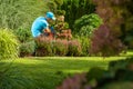 Caucasian Homeowner Performing Backyard Maintenance Royalty Free Stock Photo