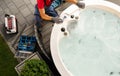 Caucasian Hot Tub Technician Servicing Circular Garden SPA Royalty Free Stock Photo