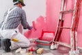 Professional house painter at work painting the wall Royalty Free Stock Photo