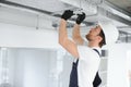 Caucasian HVAC Technician Worker in His 40s Testing Newly Installed Warehouse Ventilation System. Commercial Heating Royalty Free Stock Photo