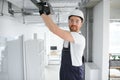 Caucasian HVAC Technician Worker in His 40s Testing Newly Installed Warehouse Ventilation System. Commercial Heating Royalty Free Stock Photo