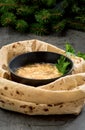 Caucasian khash soup in a bowl, with lavash cakes and herbs, close-up. Traditional Armenian or Turkish dish is soup, served with