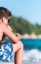 Caucasian kid sitting on the beach Royalty Free Stock Photo