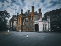 Caucasian kid walking in front of the Government House in Sydney, Australia. Royalty Free Stock Photo