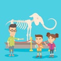 Kids with a teacher studying a skeleton in museum. Royalty Free Stock Photo