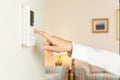 Caucasian lady pressing modern thermostat Royalty Free Stock Photo