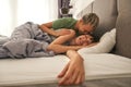 Caucasian lesbian couple lying on bed and laughing Royalty Free Stock Photo