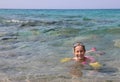 Caucasian littl girl swiming on the sea in summer Royalty Free Stock Photo