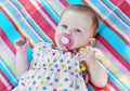 Caucasian little baby girl with multicolored frock