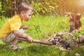 Caucasian Little Boy Dealing With Fire near Firepace Outdoors.