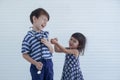 A Caucasian little boy and girl playing together acted as doctor nurse patient at home