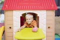 Caucasian little boy playing in a playhouse Royalty Free Stock Photo