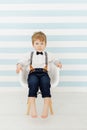 Caucasian Little Boy Sitting Straight on Chair