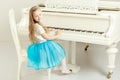 Caucasian little girl with long blond hair, in a beautiful pink