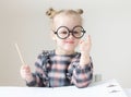 Caucasian little girl with round glasses. Little teacher