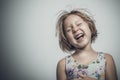 Caucasian little girl with short hair laughing carefree