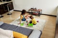 Caucasian little girl spending time with african american baby sitter. They are playing with construction toys set Royalty Free Stock Photo