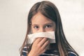 Caucasian little girl to blow her nose with hygienic wet wipe. Seasonal sickness. child sneezes into a rag. sneeze cough Royalty Free Stock Photo