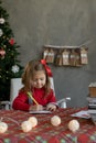 Caucasian little girl writes a Christmas letter to Santa, the child makes a list of gifts for the New Year, Happy Royalty Free Stock Photo