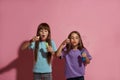 Caucasian little girl friends blow bubbles blower