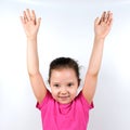 Caucasian little smiling girl raising her hands up on white background. Sport, physical training, physical jerks, healthy