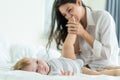 Caucasian loving mom play with cute baby boy child on bed in bedroom. Happy family, attractive beautiful caring young mother kiss Royalty Free Stock Photo