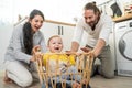 Caucasian loving parents play with baby toddler in kitchen on floor. Beautiful couple mother and father play with young little son Royalty Free Stock Photo