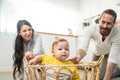 Caucasian loving parents play with baby toddler in kitchen on floor. Beautiful couple mother and father play with young little son Royalty Free Stock Photo