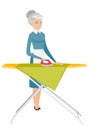 Caucasian maid ironing clothes on ironing board. Royalty Free Stock Photo