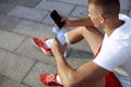 Fit young man looking at his smartphone Royalty Free Stock Photo